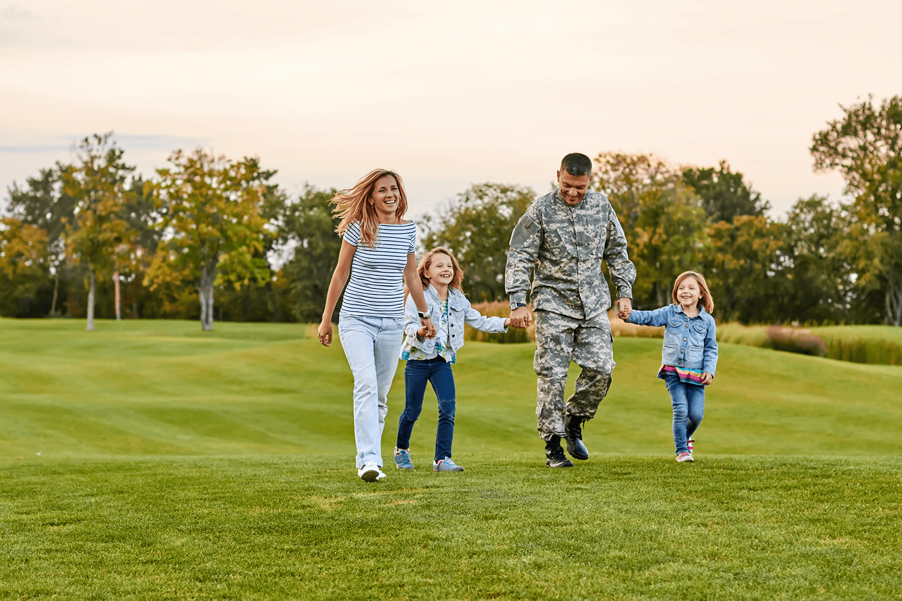 Service member walking with his family outdoors